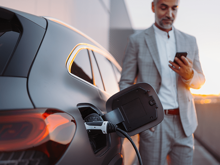 Business Person charging an Electric Vehicle